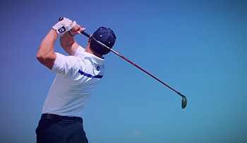 Male swinging a golf club