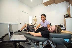 Annie Tey performing ultrasound on a women's health client