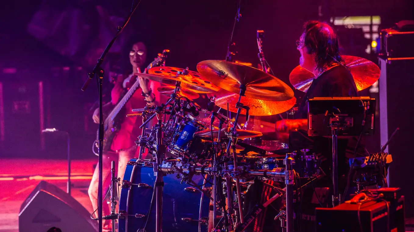 Drummer plays live on stage during festival concert
