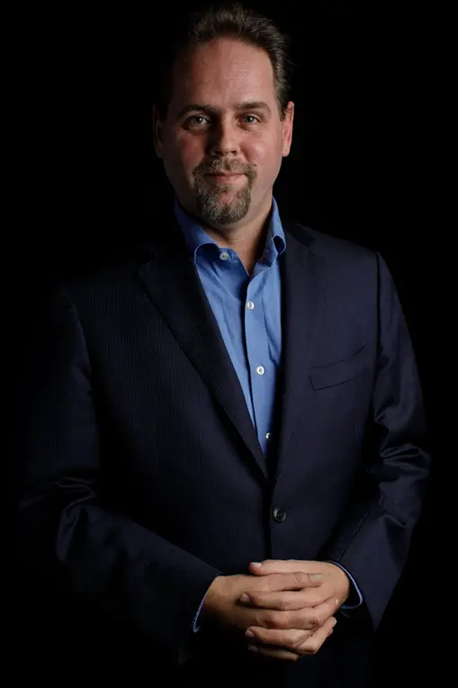 Business portrait of a bearded man in a blue blazer