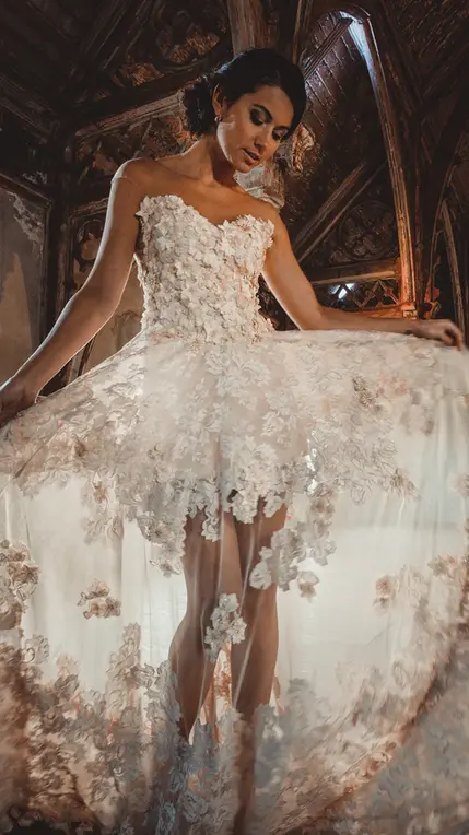 Model in sheer couture dress on classic stairs