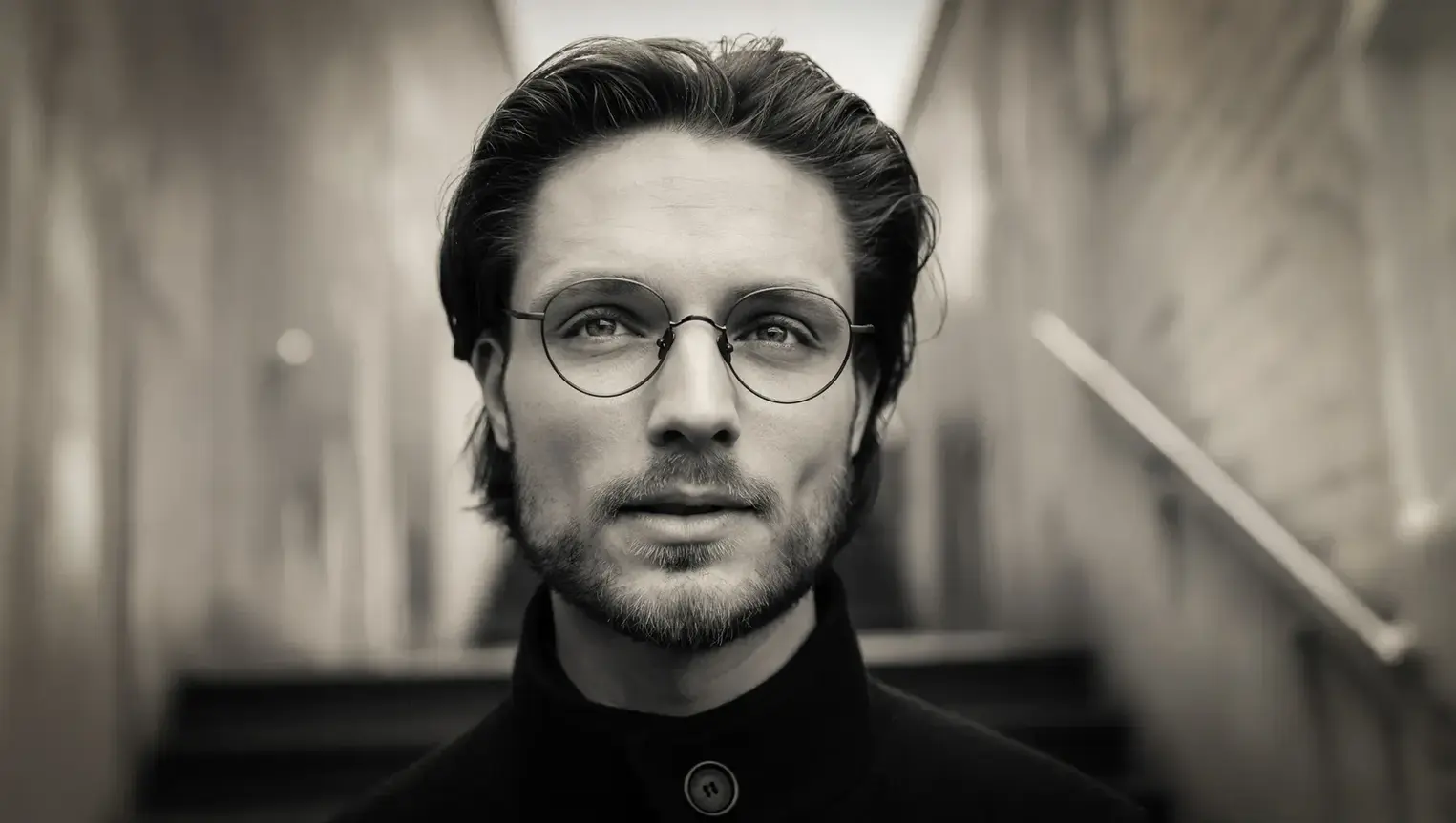 Close-up portrait of a man wearing designer glasses