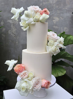 tall white cake with colorful flowers