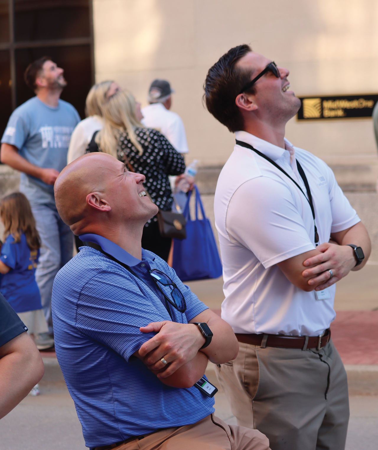 Two Cottingham & Butler team members watch participants rappel for United Way's Over the Edge.