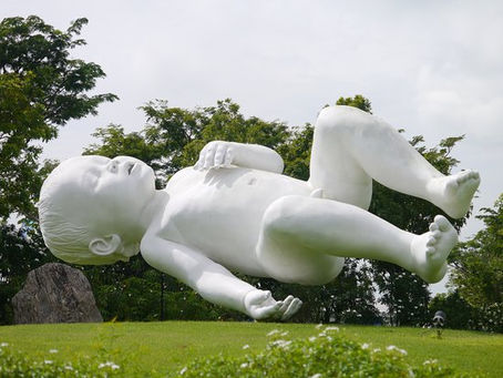 Floating baby sculpture 'Planet' at Gardens by the Bay, Singapore.