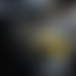 A person using a yellow cloth to clean a car