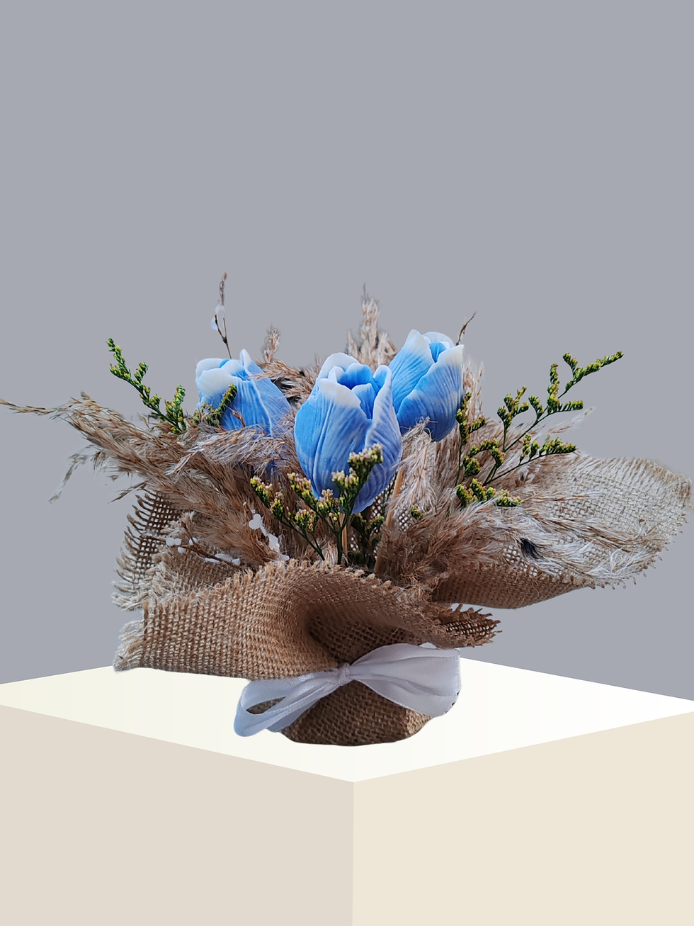 Scented blue tulip floral arrangement with natural jute detail on neutral grey background