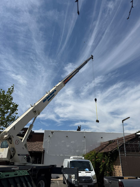 State Crane Services crane boom at a high angle against the sky showing maximum reach
