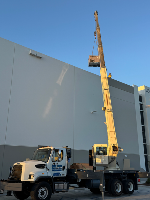 Mobile crane lifting rooftop AC unit on commercial building in Southern California serving Los Angeles Orange County San Bernardino and Inland Empire