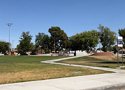 Lancaster skate park with ramps and green lawn in Lancaster California