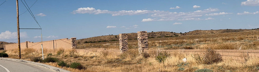 Block walls and stone entry pillars staged for future development along the Anaverde fire-access road out to Elizabeth Lake Road in west Palmdale