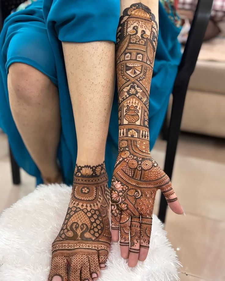 peacocks cultural mehndi design on left hand and left foot