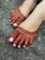 feet full of mehndi on fingers