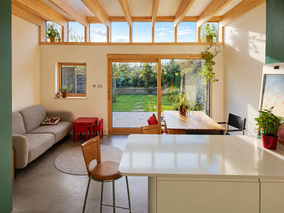 bright extension with exposed timber structure eco home