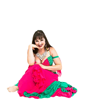 Dancer in pink and green costume sitting on ground. She is looking at you and smiling.