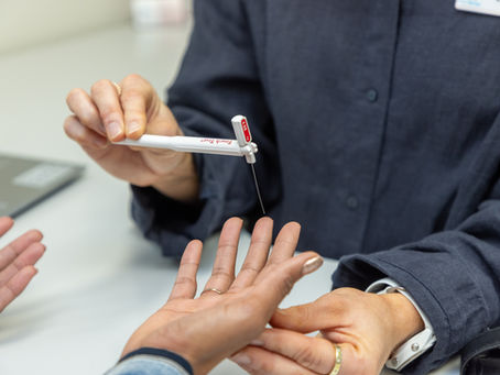 A hand therapist testing the sensation of a hand using monofilaments