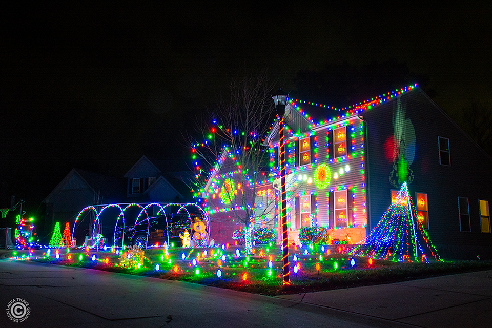 This house of Christmas lights can be seen from far away because it's so tall.