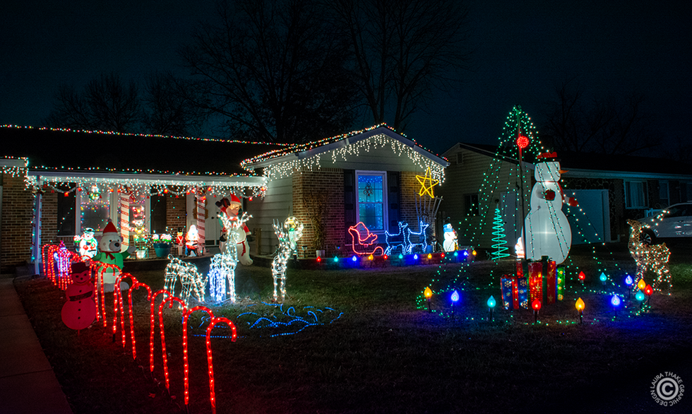 Christmas blow molds and lights strung on the house.