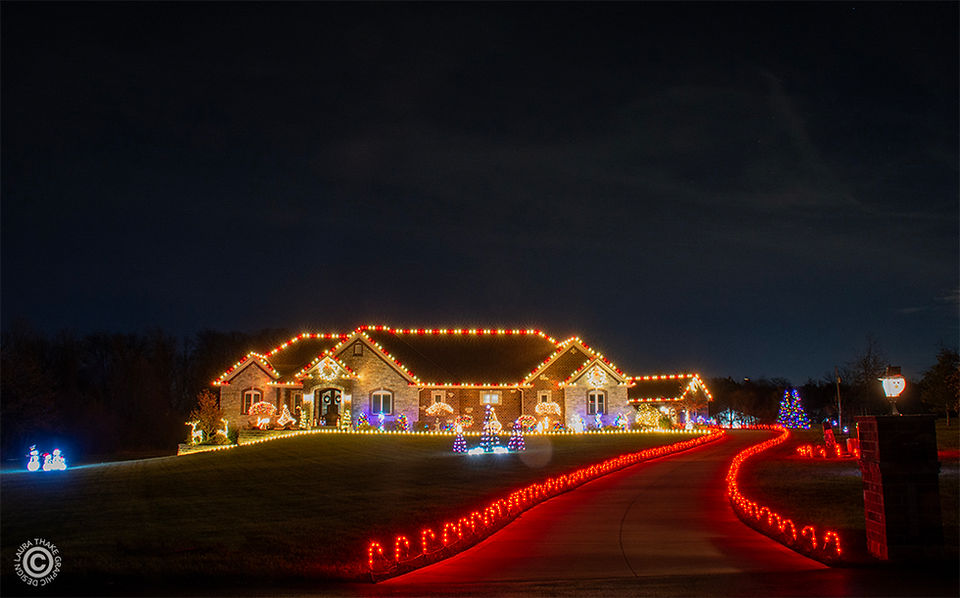 A house covered in Christmas lights with red candy canes.