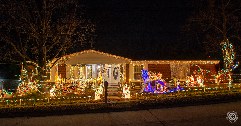 A winter wonderland in white lights with charming scenes all across the yard.