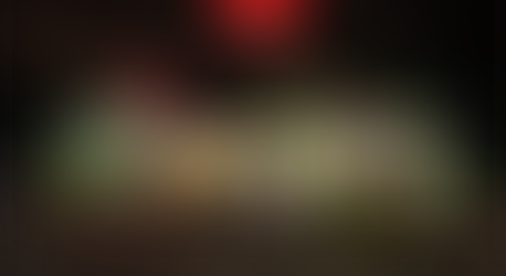 LED Christmas lights covering a house and yard in red, green and white lights.