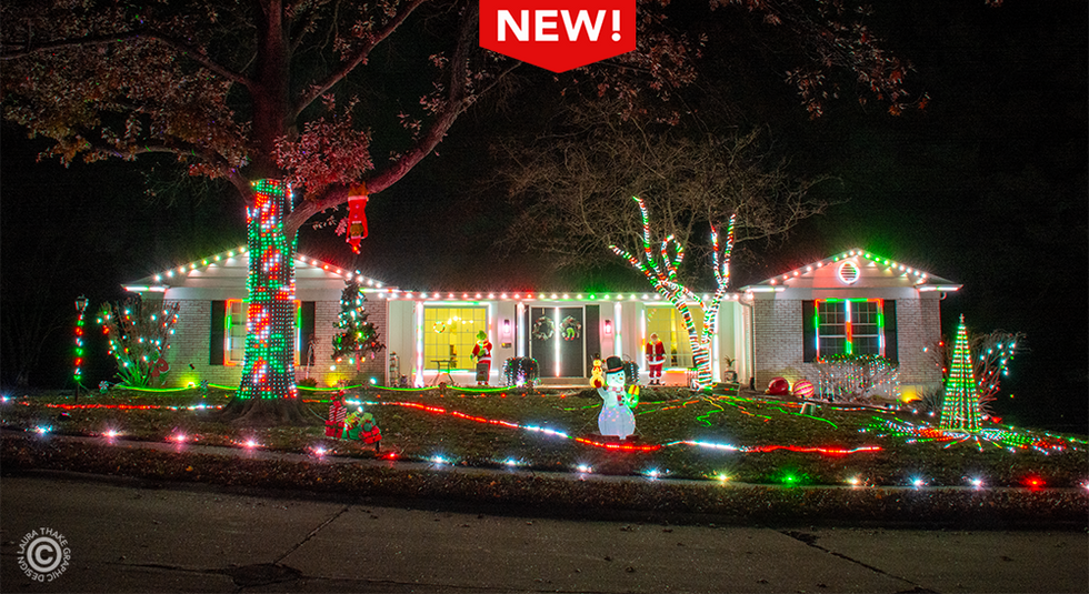 LED Christmas lights covering a house and yard in red, green and white lights.