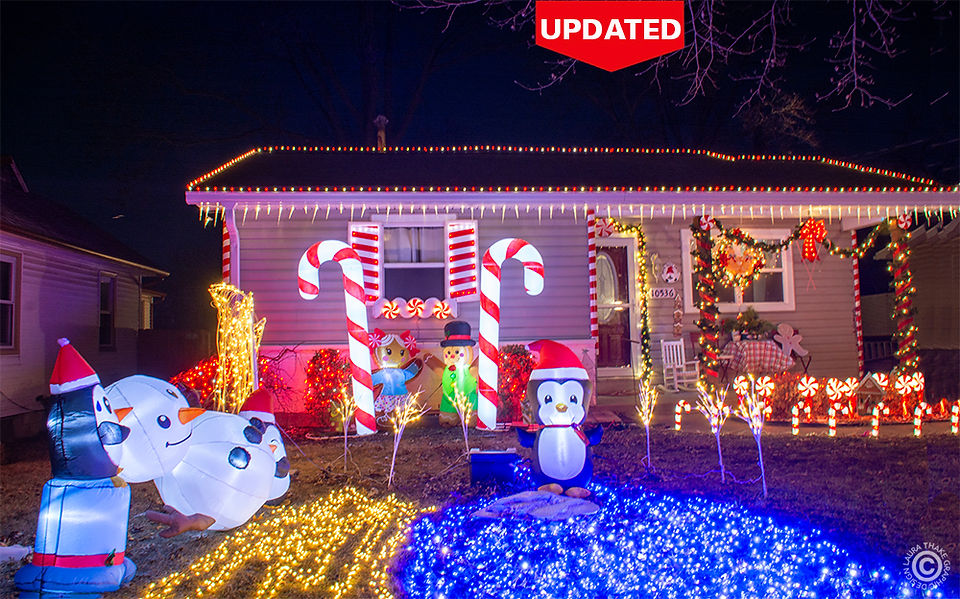 A gingerbread house in red and white lights.