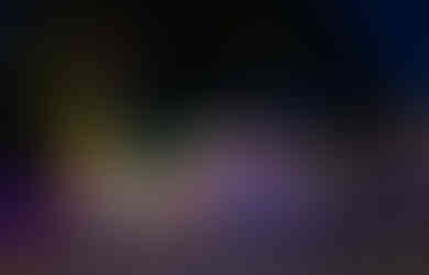 Skeletons in the tree and pumpkins on the ground intermix with the lights.