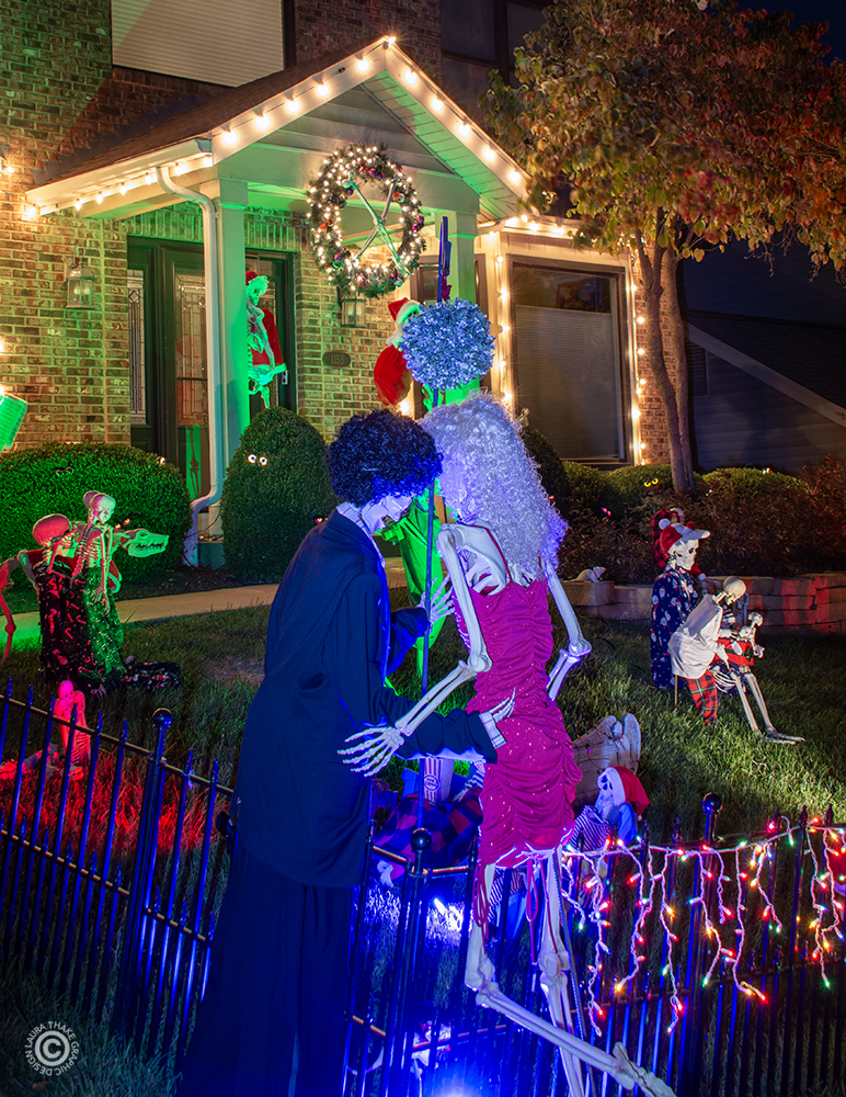 Skeletons kissing under the mistletoe.