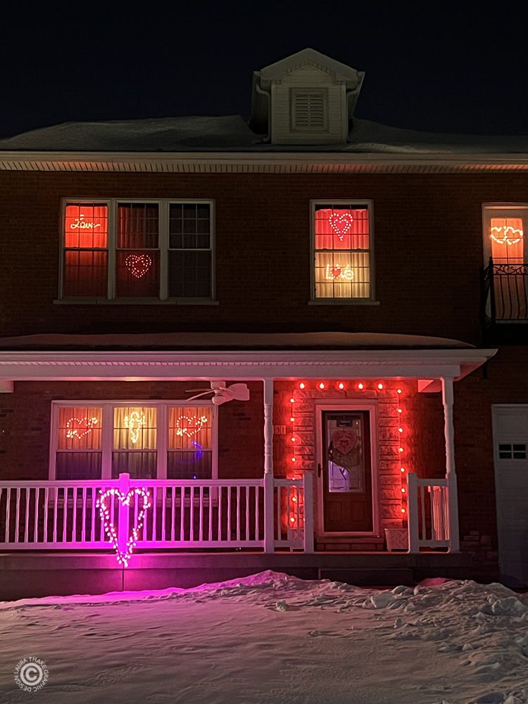 Love is in the air at this house with red and pink lights.