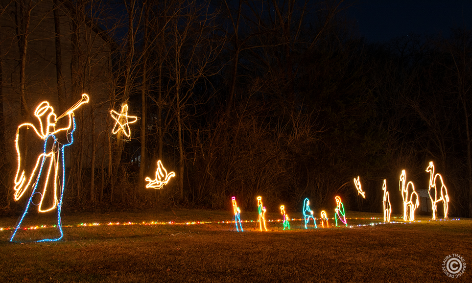 The nativity and angel with camels in the distance.