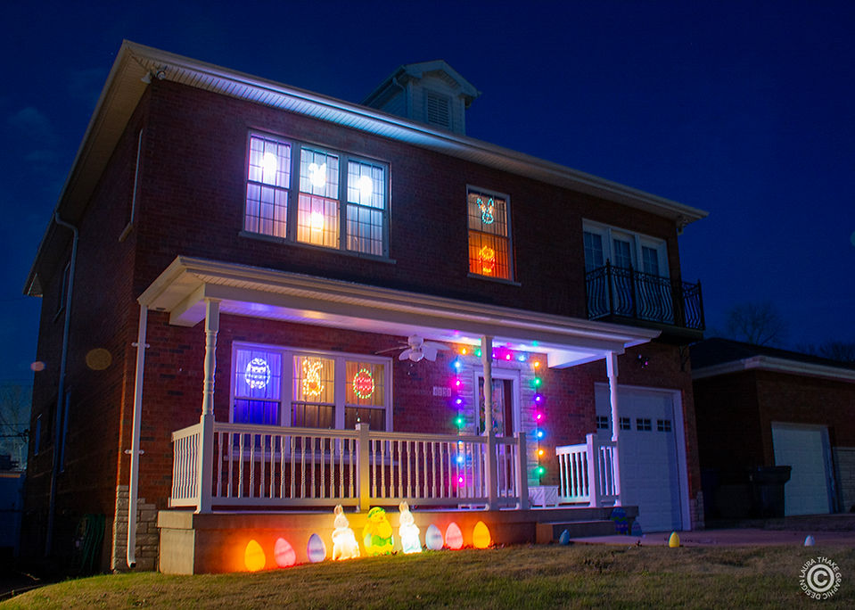 Glowing blow molds for Easter are lined up against the front porch and lights are in all the windows. This house is located in the Carnodelet Park area.