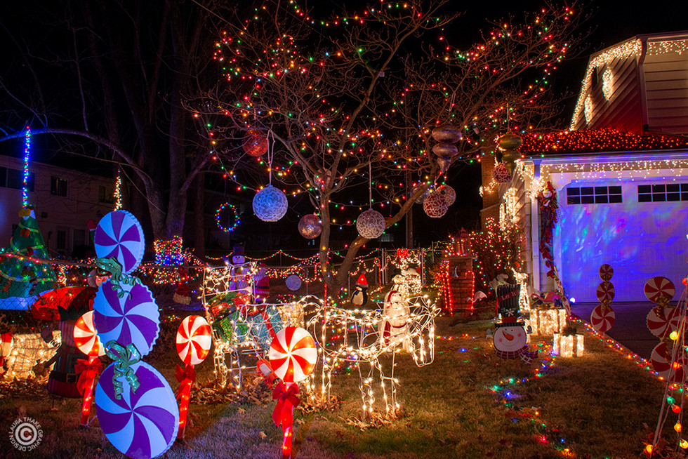 Lots of cute Christmas decorations in the yard of a house.