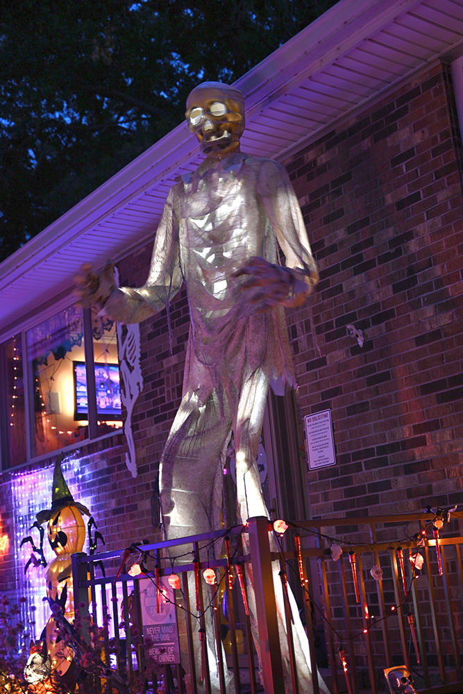 A 12 foot tall mummy stands by the front door for trick or treaters to meet.