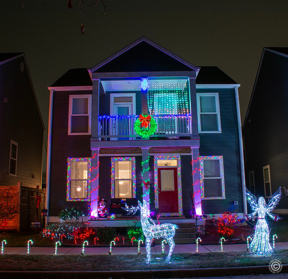 Lights set to music amongst the row of houses. Roll down your window to hear.