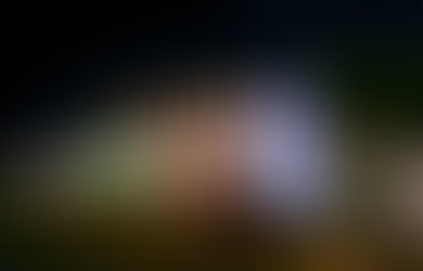 A 20 foot tall Snowman inflatable standing in front of a house covered in Christmas lights.