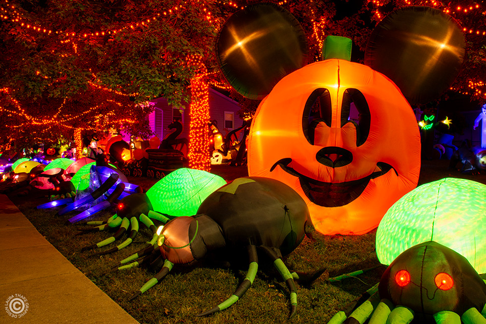 Inflatable spiders and a giant pumpkin with Mickey Mouses face on it.