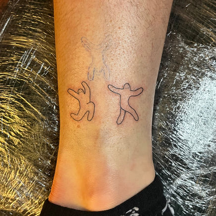 Two simple tattoos on white skin.