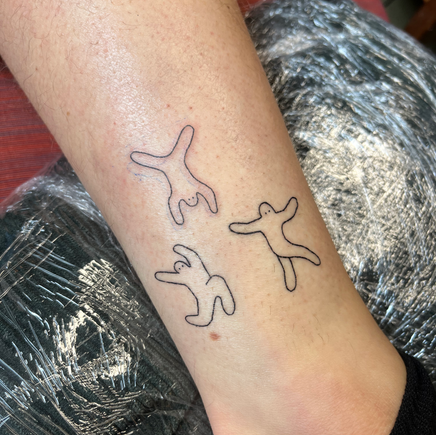 Three simple tattoos on white skin.