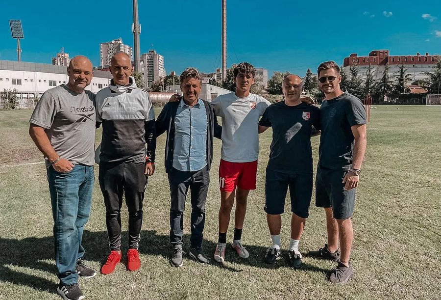 Arkadiy Galperin with coaches and a young player at a club training ground