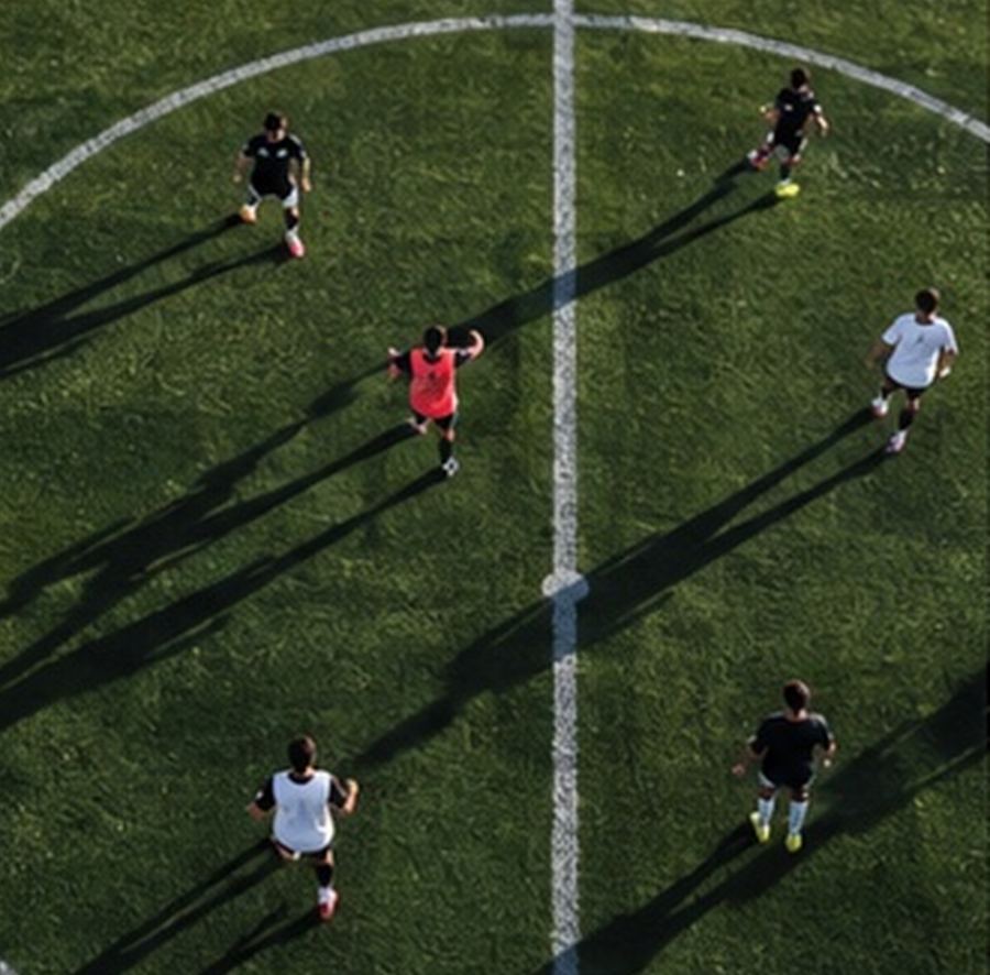 Players training on a pitch, seen from above