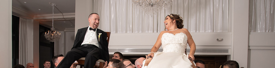 Wedding couple lifted on chairs