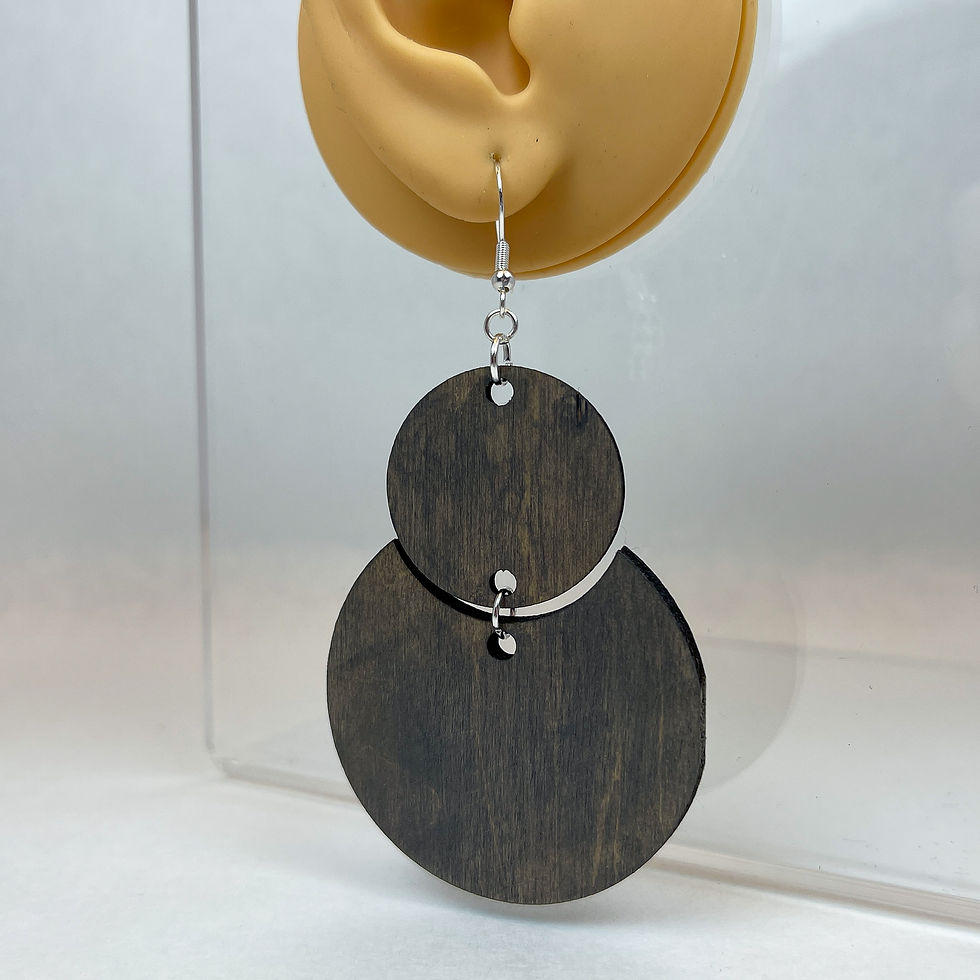 Thumbnail: Handmade circle and crescent wooden earrings that dangle off of each other from a silver plated hook.