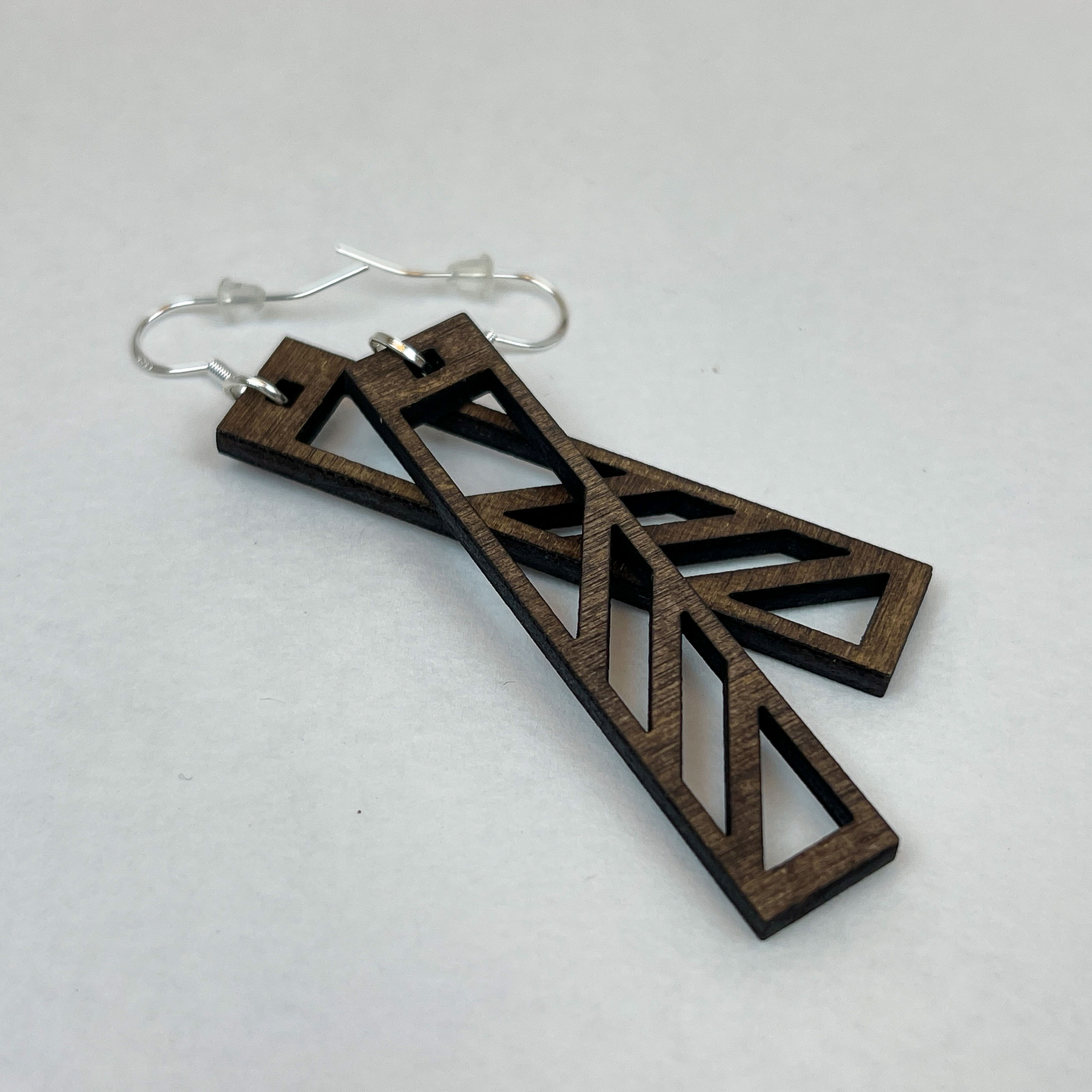 Lightweight earrings made from stained wood with a unique cut-out pattern.