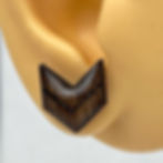 Glossy handmade wood earrings in a chevron shape stained in a dark oak stain. Minimalistic stud earring.
