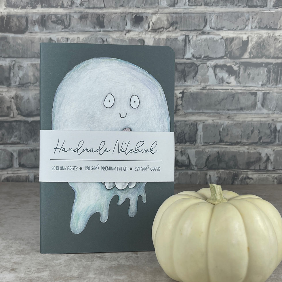 Staple bound notebook with a hand drawn gray ghost holding a white pumpkin on a charcoal background.