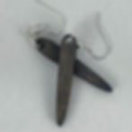 Handmade teardrop wooden earrings that dangle off of a silver plated hook.