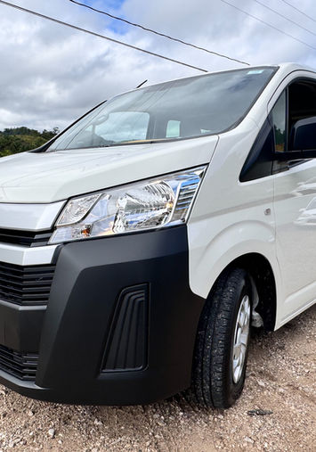 Spacious 12-seater van with luggage capacity for group shuttle service from San Ignacio to Dangriga