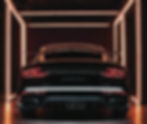 aesthetic black car taillights on in a dark showroom lit with LED lights.jpg