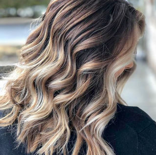 Long highlighted wavy balyage brown and blonde ombre hairstyle, done at Panache Hair Design, Located in Shelton, CT.